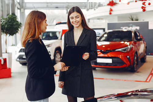 positive-gorgeous-agent-sharing-contract-with-client-in-car-4173194.jpg